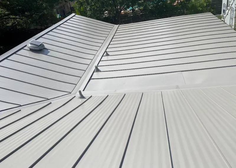Solar attic fan installed on a metal roof for Roof Ventilation in Liberty